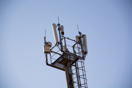 Top side of mast with an equipment for cellular communication. Tower with platform and stairway.の写真素材