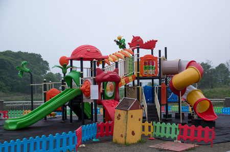 Children playground with plastic slide. Kid's colorful area.Modern children playground in parkの写真素材