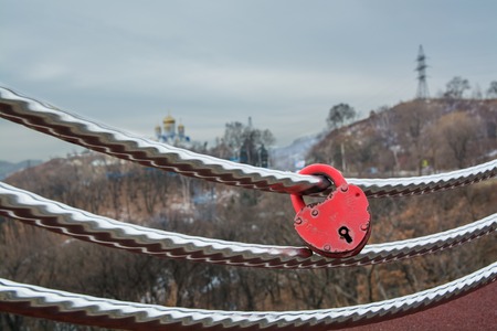 Wedding lock in shape of heart on a handrail. Symbol of marriage.の写真素材