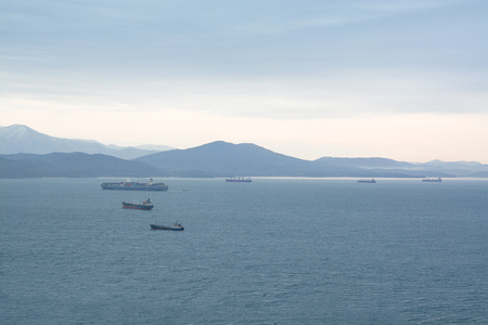 Sea vessels on raid in the bay. Hills on background.の写真素材