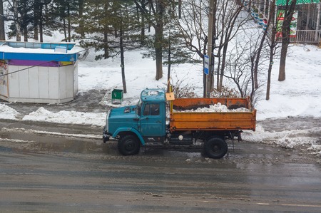 Dump truck with snow. Top view on the dirty roadway.の写真素材
