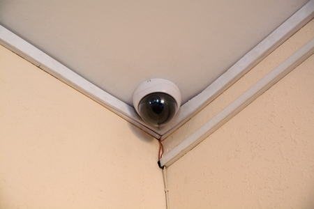 Security camera monitor in office building. Spherical CCTV under ceiling.の写真素材