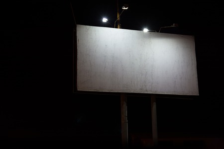 Night View Of Big Billboard Illuminated By Lanterns. Empty Adware Space.