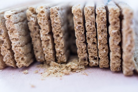 Grain crisp bread and crumbs closeup. Side viewの写真素材