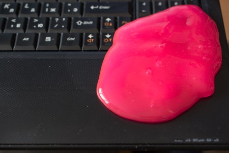 Keyboard Cleaning Gel Is Laying On The Keyboard. Notebook and Pink Gel.の写真素材