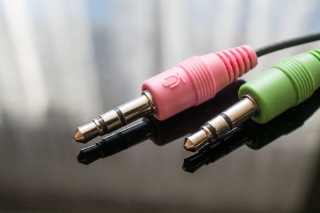 Two Headphones Jack on Black Background. Surface with Reflectionの写真素材