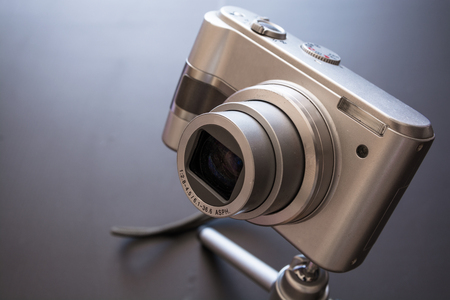Silver compact digital photo camera. Top view.