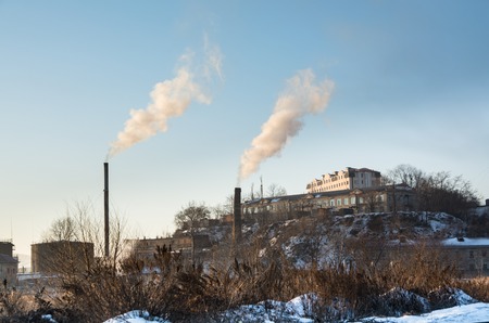Two Big Steamshop's Pipe on Background. Smoke Is Rising Up.の写真素材