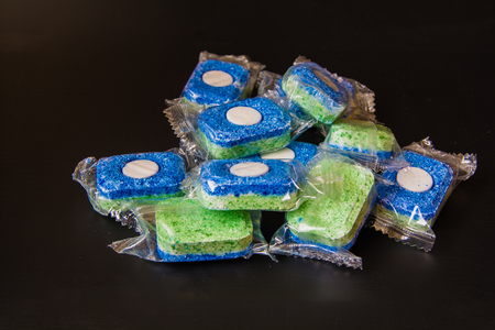 Tablets for Dishwashing Machine on a Black Background. Tablets In a pack.の写真素材