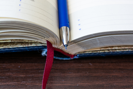 Open diary notebook with bookmark. Close up view from the side.の写真素材