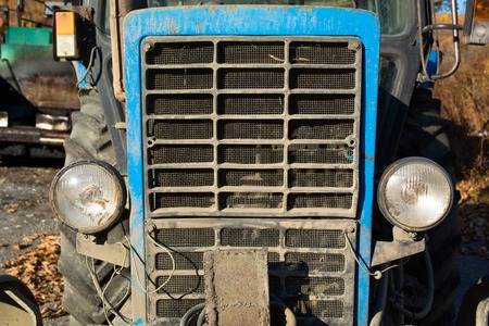 Front view of old tractor. Front light of car,agricultural industrial machine, detail and part of...