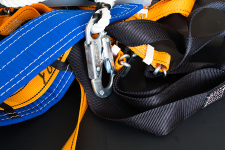 Equipment for work at heights. Sit harness on a dark background.の写真素材