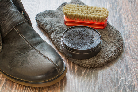 Accessories for shoes cleaning. Man's shoes on wooden surface.の写真素材