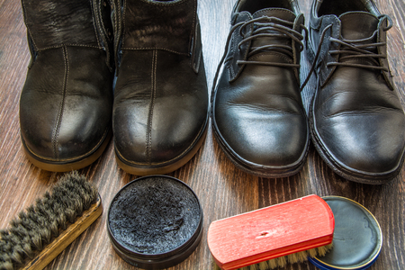 Accessories for shoes cleaning. Man's shoes on wooden surface.の写真素材