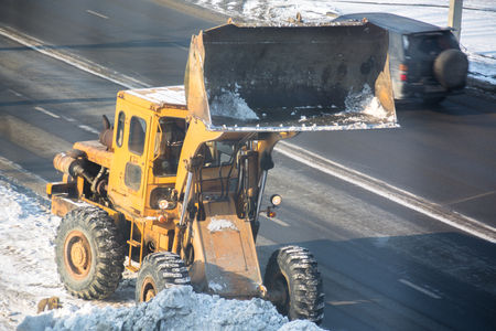 Snow removal vehicle. Tractor clears the way after snowfall.の写真素材