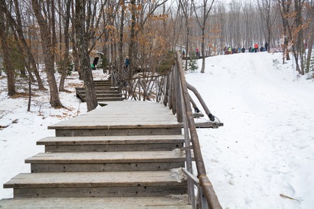 Snow covered stairs near the ice slope. Winter parkland.の写真素材
