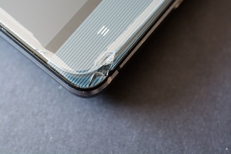 Close up of broken smart phone. Crashed glass of a phone display.の写真素材