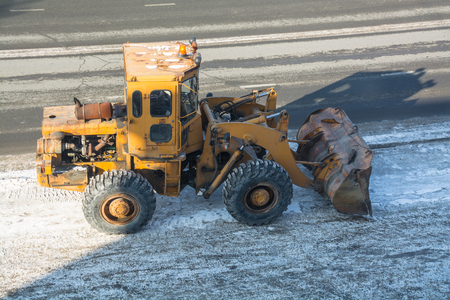 Snow removal vehicle. Tractor clears the way after snowfall.の写真素材