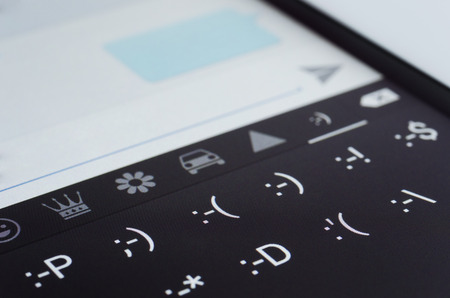 Smile icons on new smartphone screenの写真素材