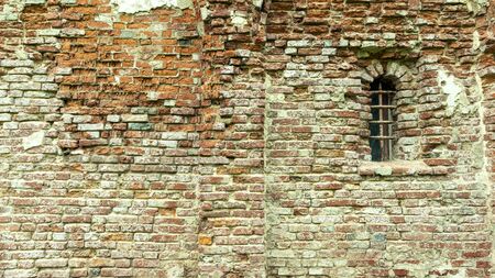 crumbling church wall of red brick with plasterの写真素材