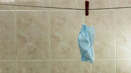 medical mask hanging on a rope after washingの写真素材