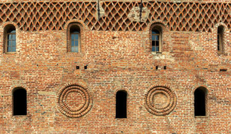 Windows of a brick tower in the Gothic style