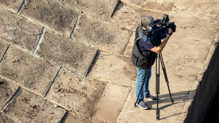 a male cameraman is videotaping from the Marinaの写真素材