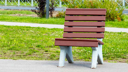 brown wooden bench in a public Park