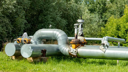 two large water pipes with a valve in the Park