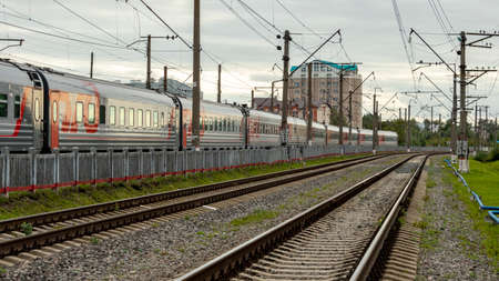 a long train of cars on the railway tracksの写真素材