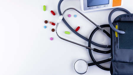 Medical device for measuring blood pressure with tablets on  whiteの写真素材