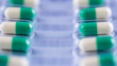 packaging white-green pills macro photographyの写真素材
