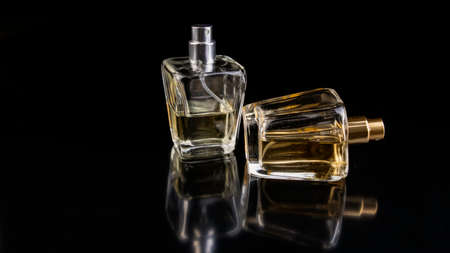two bottles of perfume essences on black background,の写真素材