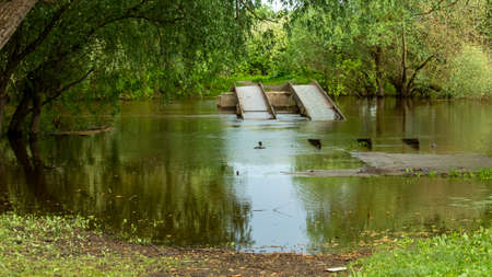 a large iron bridge connecting the two shores is flooded with water