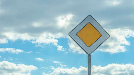 road sign main road on a background of a clear blue sky, minimalism
