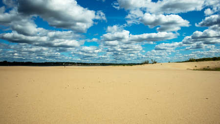 landscape sandy beach on the background of blue cloudy sky, backgrounds, texturesの写真素材