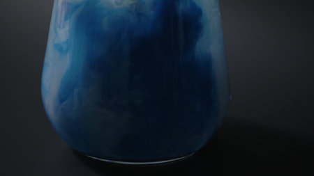 splashes of multi-colored paints in a glass of water,
