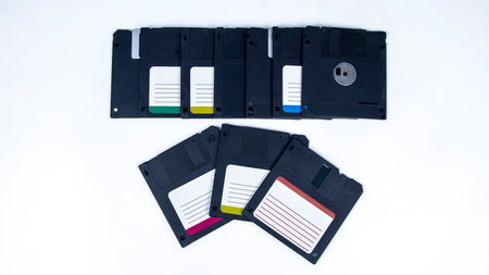 obsolete computer floppy disks with a flash drive on a white background,