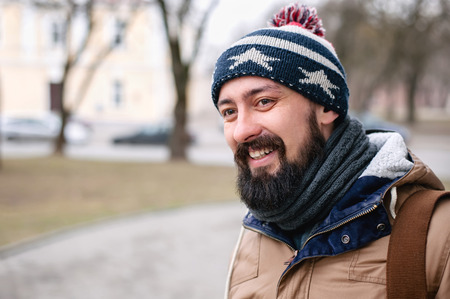portrait of smiling urban stylish bearded man on the street, lifestyleの写真素材