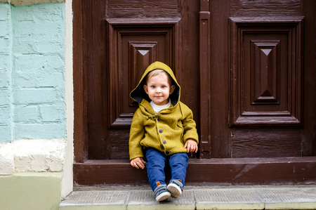 beautiful boy on a walk in the city with his parents in fashionable clothesの写真素材