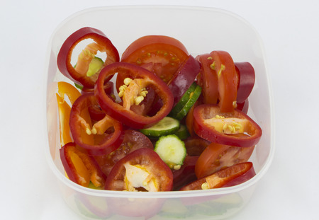 Healthy food fresh vegetable salad in a square bowl on white backgroundの写真素材