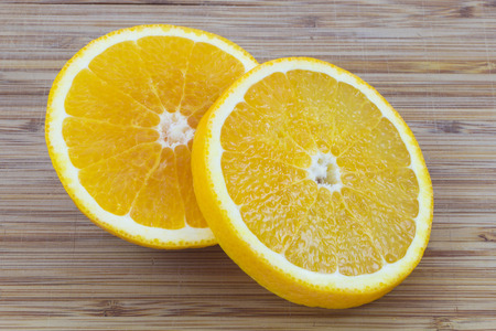 Two delicious orange slices on woodの写真素材