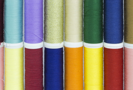 The combination of colorful spool arranged in two rowsの写真素材
