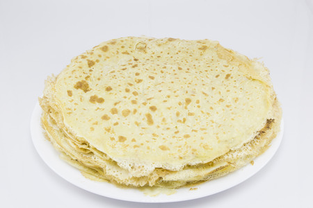 Fried crepes (pancakes) in white plate on white background