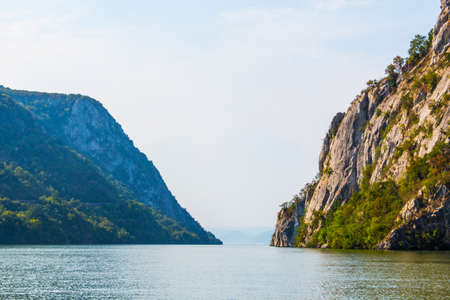 View of the gorges (Serbia left, Romania right) along Danube river, during summer.の写真素材