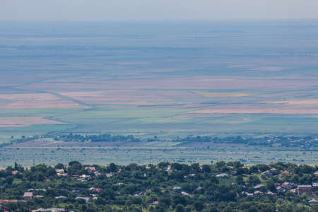 An aerial view of several agricultural plots near a Romanian village.の写真素材