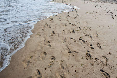 The water of Black Sea washing footprints on the Albena beach in Bulgaria.の写真素材