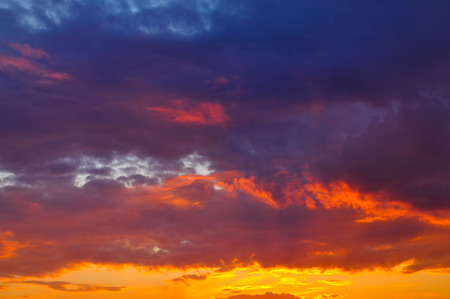Sunset with clouds, in orange and purple shadesの写真素材
