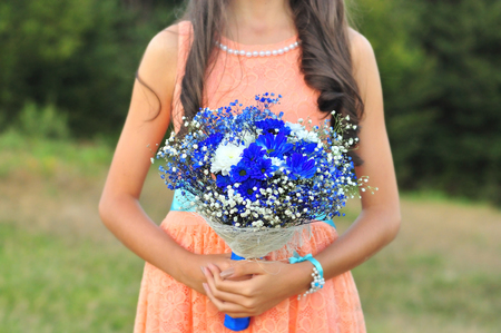 Maid of honor holding brides blue bouquetの写真素材
