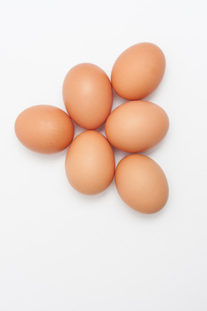 Pyramid shaped chicken egg pile, isolated on white backgroundの写真素材